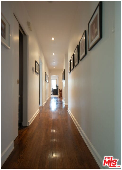 corridor featuring dark hardwood / wood-style floors