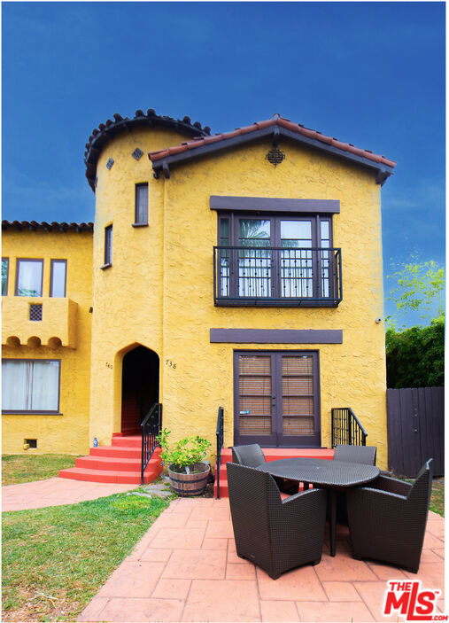 back of house featuring a patio and a balcony