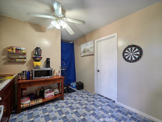 interior space with ceiling fan