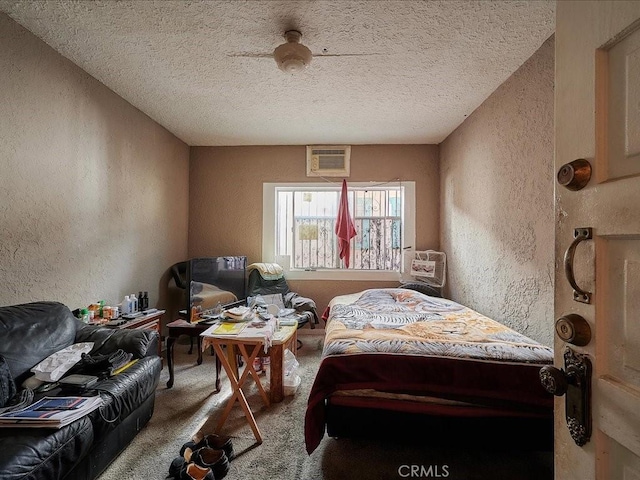 carpeted bedroom featuring ceiling fan and a textured ceiling