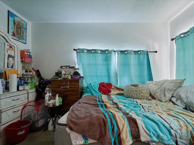 bedroom with carpet flooring and a textured ceiling