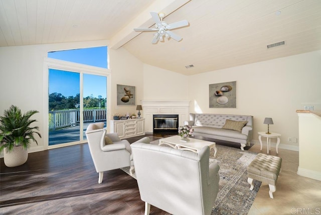 living room with lofted ceiling with beams, dark hardwood / wood-style floors, and ceiling fan