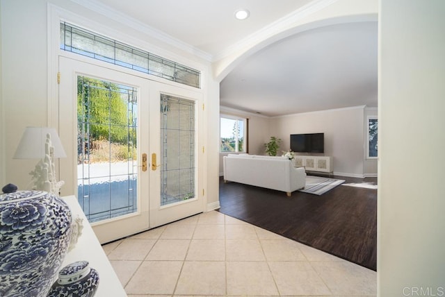 entryway with french doors, light hardwood / wood-style floors, and ornamental molding