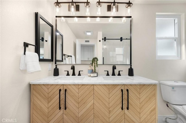 bathroom featuring vanity and toilet