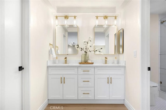 bathroom featuring vanity, wood-type flooring, and walk in shower