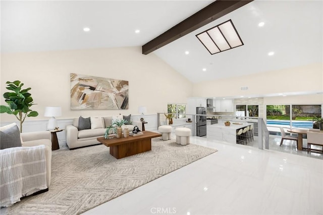 living room with beamed ceiling and high vaulted ceiling