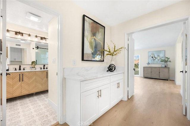 hall featuring light hardwood / wood-style flooring and sink