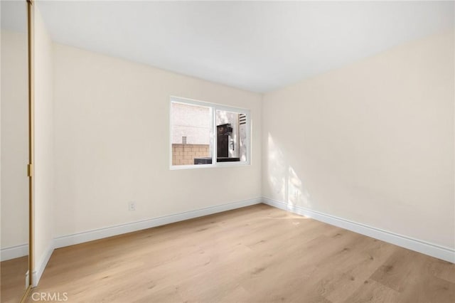 empty room with light hardwood / wood-style floors