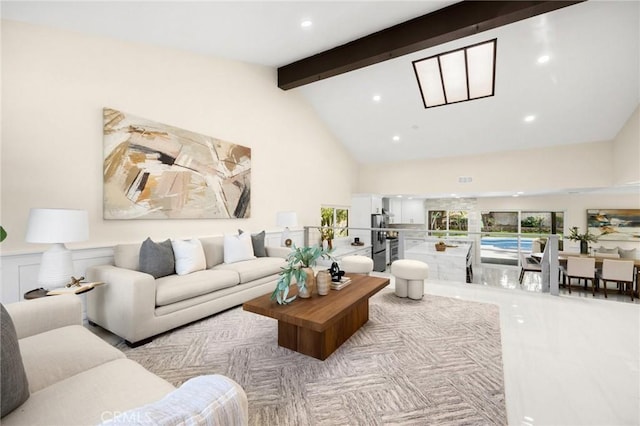 living room with beamed ceiling and high vaulted ceiling