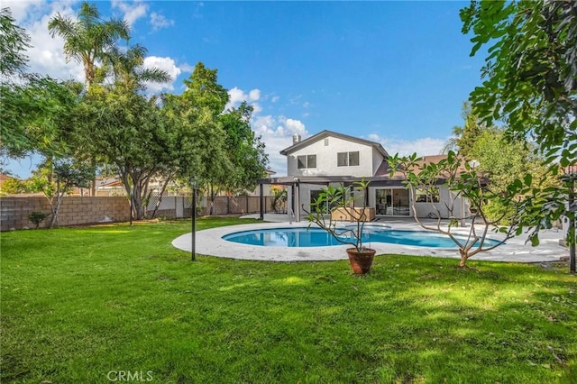 view of pool featuring a yard and a patio