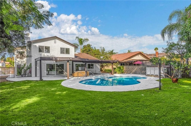 view of pool with a patio area and a yard