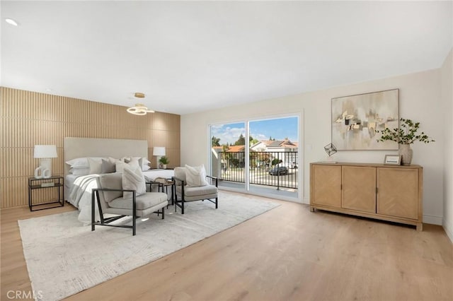 bedroom featuring access to exterior and light hardwood / wood-style flooring