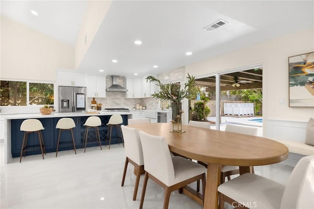 dining space featuring vaulted ceiling and ceiling fan