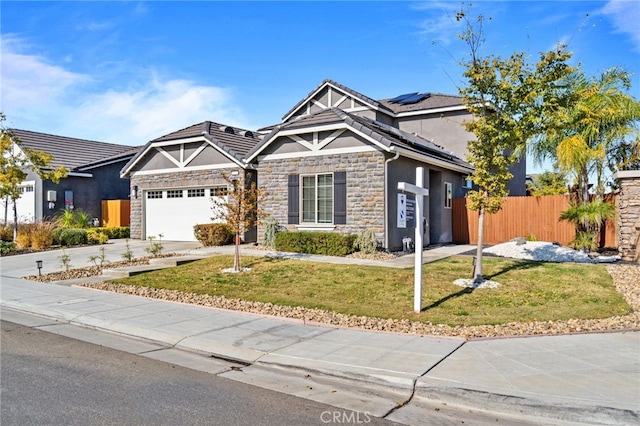 view of front of house featuring a front yard, solar panels, and a garage