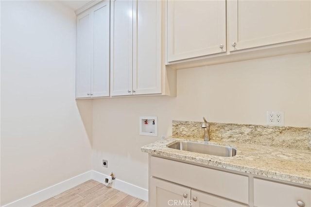 laundry room featuring sink, cabinets, washer hookup, electric dryer hookup, and light wood-type flooring