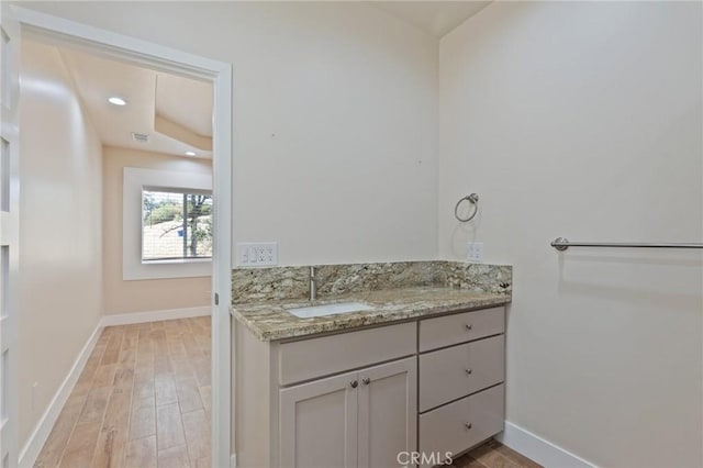 bathroom featuring hardwood / wood-style floors and vanity