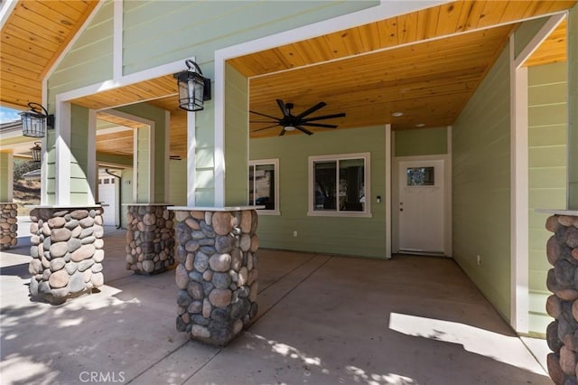 view of patio / terrace featuring ceiling fan and a bar