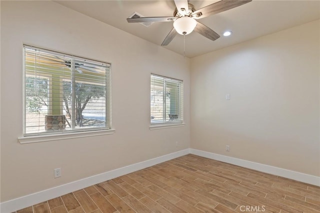 empty room with light hardwood / wood-style floors, plenty of natural light, and ceiling fan