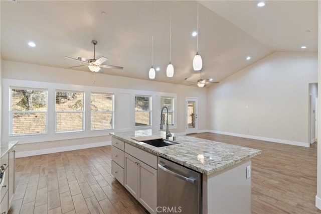 kitchen featuring sink, stainless steel dishwasher, an island with sink, vaulted ceiling, and white cabinets