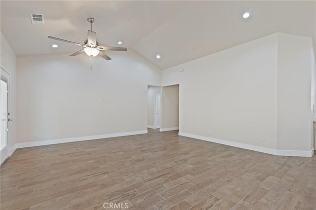 unfurnished room with ceiling fan, light hardwood / wood-style flooring, and vaulted ceiling