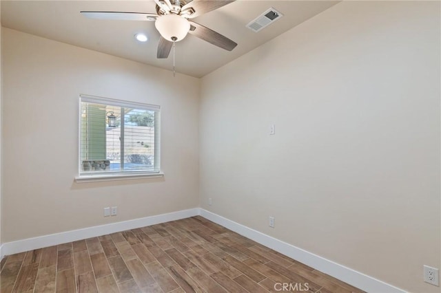 empty room with hardwood / wood-style floors and ceiling fan