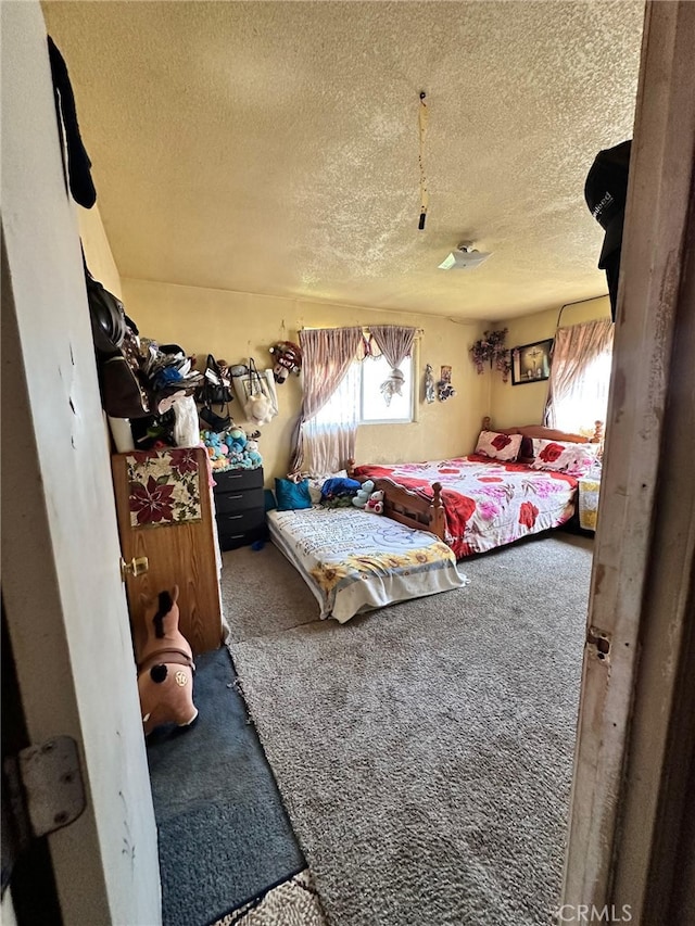 carpeted bedroom with a textured ceiling