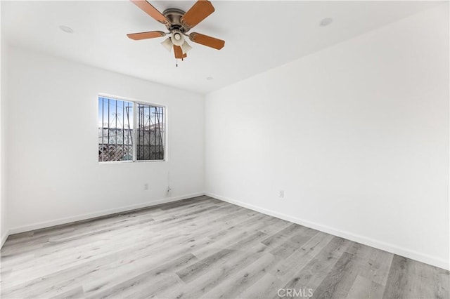 empty room featuring ceiling fan and light wood-type flooring