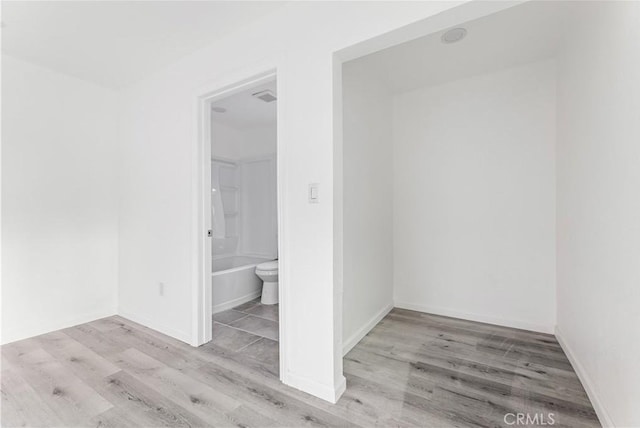 empty room with light hardwood / wood-style floors