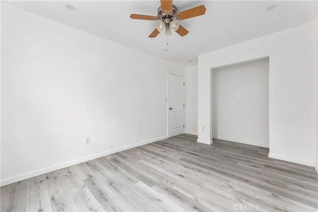 unfurnished bedroom with ceiling fan and light wood-type flooring