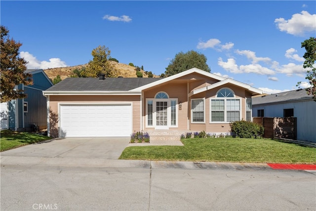 ranch-style house with a front yard and a garage