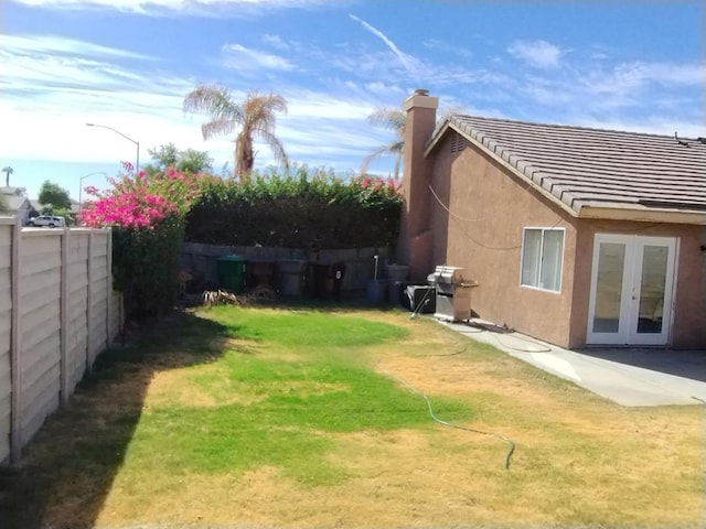 view of yard featuring french doors