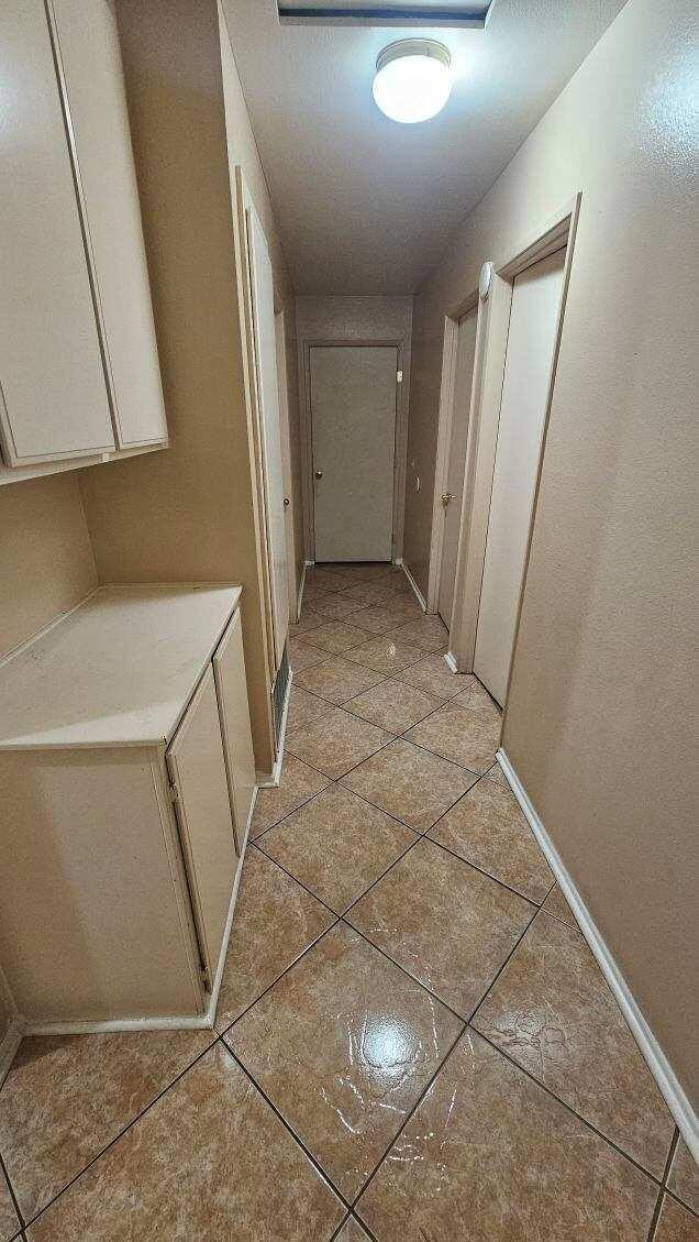 hallway featuring light tile patterned floors