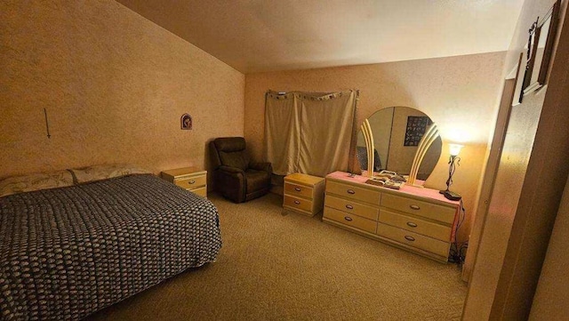 carpeted bedroom with lofted ceiling