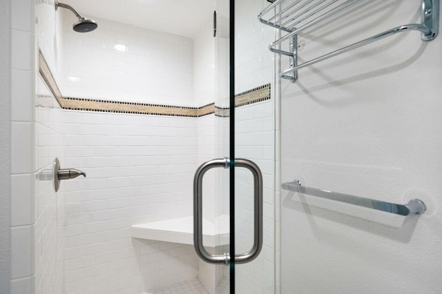 bathroom featuring a shower with shower door