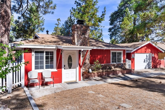 ranch-style home with an outbuilding and a garage