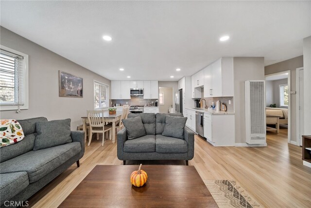 191 Los Angeles Ave, Sugarloaf, CA 92386 - living room featuring a heating unit, healthy amount of natural light, light wood-type flooring, and recessed lighting