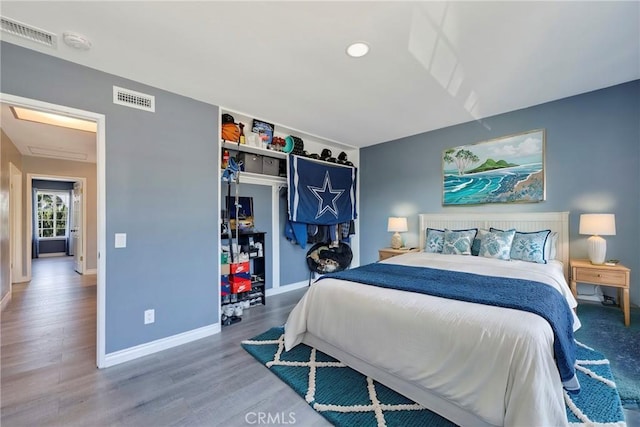 bedroom with wood-type flooring