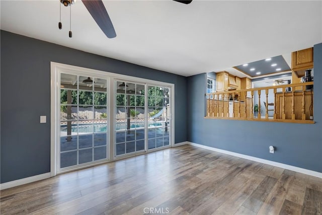 spare room featuring ceiling fan and hardwood / wood-style floors