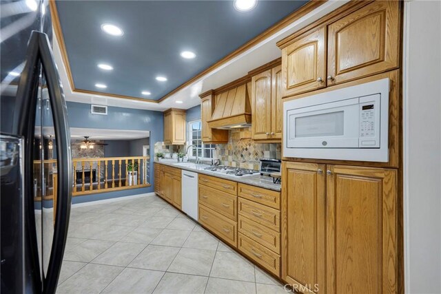 kitchen with ceiling fan, light tile patterned flooring, white appliances, and custom range hood