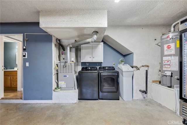 washroom with cabinets, gas water heater, separate washer and dryer, heating unit, and a textured ceiling