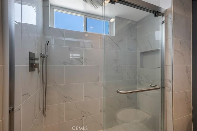 bathroom with a shower with shower door