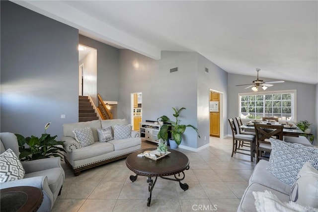 living room with ceiling fan, light tile patterned flooring, and vaulted ceiling