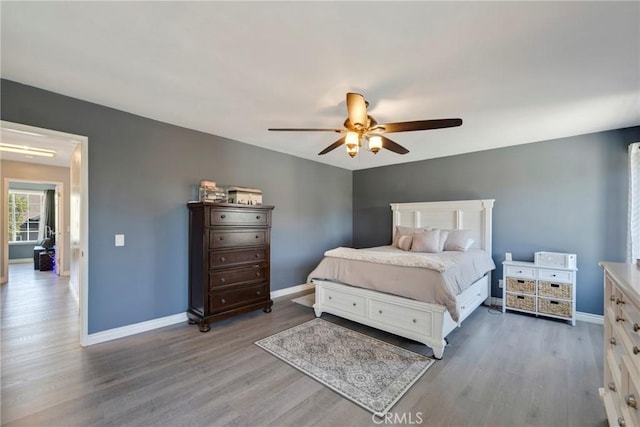 bedroom with ceiling fan and hardwood / wood-style floors