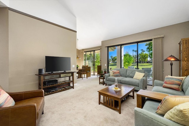 living room with light colored carpet and high vaulted ceiling