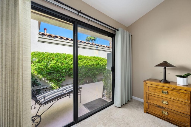 entryway with lofted ceiling, carpet, and a wealth of natural light