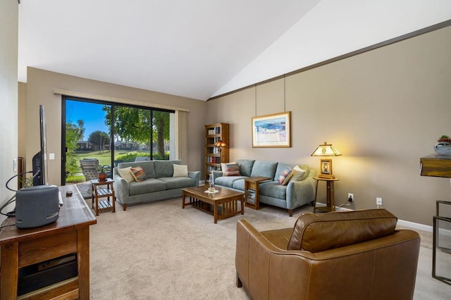 carpeted living room with high vaulted ceiling