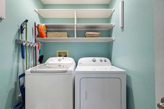 clothes washing area featuring separate washer and dryer