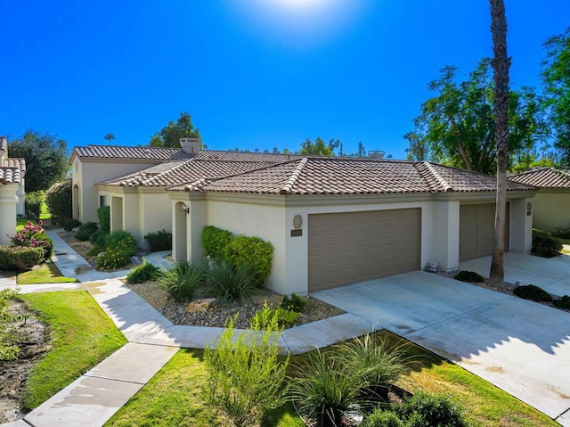 mediterranean / spanish house featuring a garage