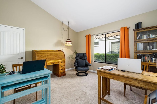 carpeted office space featuring vaulted ceiling