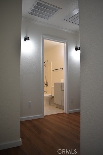 corridor with crown molding and wood-type flooring